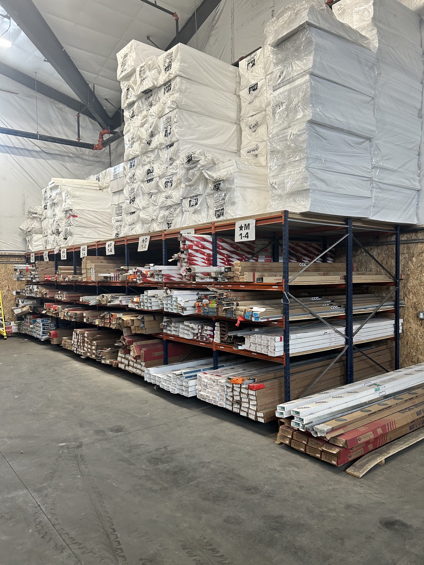 Building materials arranged on warehouse racks